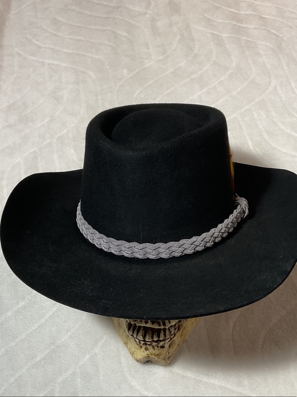 Vintage black felt cowboy hat with feather and braided trim
